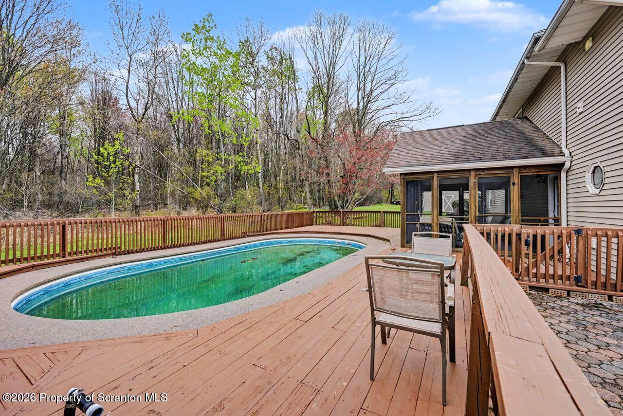 73 Quinton Road Scott Township, PA 18447 - Photo 58 of 64 swimming pool view with a seating space and garden view