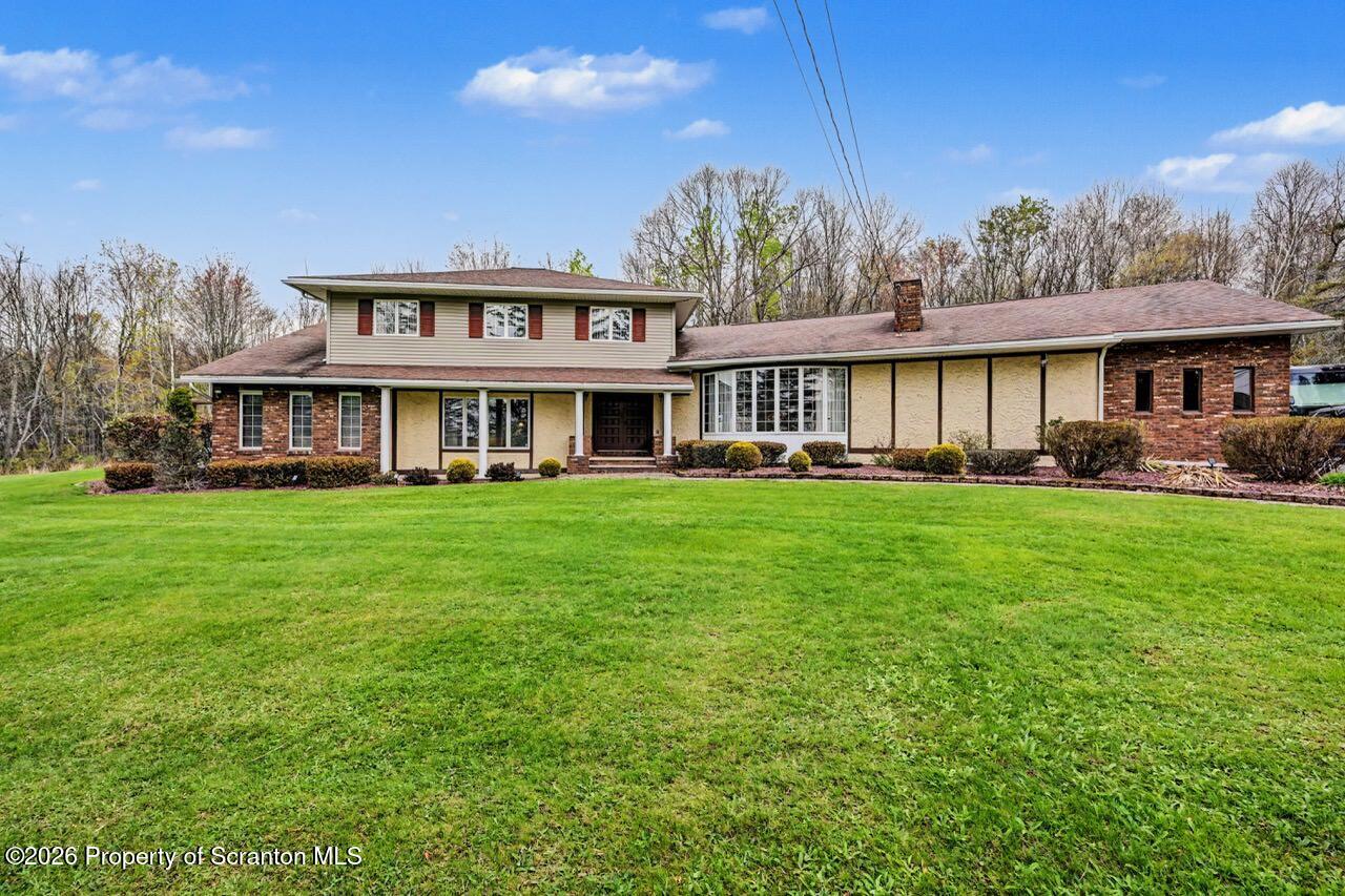 73 Quinton Road Scott Township, PA 18447 - Photo 63 of 64 a front view of a house with a yard table and chairs