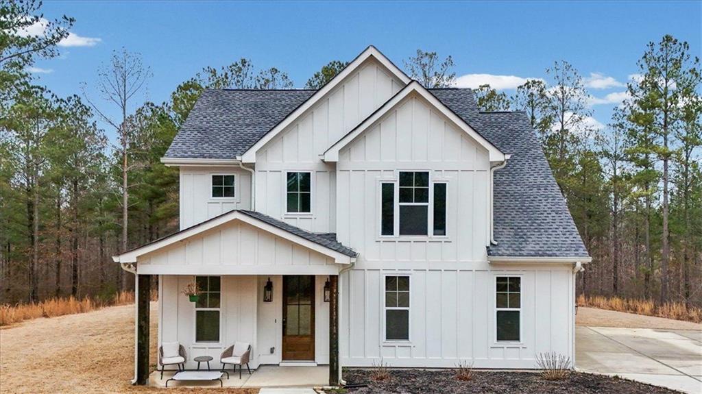 1270 McGarity Road Temple, GA 30179 - Photo 1 of 58 a view of a white house with large windows and a small yard