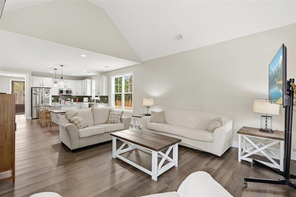1270 McGarity Road Temple, GA 30179 - Photo 13 of 58 a living room with furniture and a view of kitchen