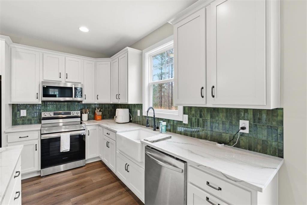 1270 McGarity Road Temple, GA 30179 - Photo 17 of 58 a kitchen with white cabinets appliances and sink