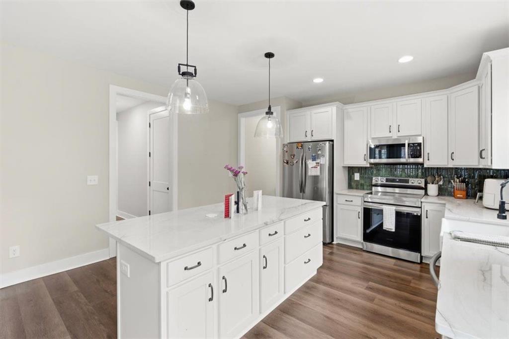 1270 McGarity Road Temple, GA 30179 - Photo 18 of 58 a kitchen with stainless steel appliances kitchen island granite countertop a sink refrigerator and cabinets