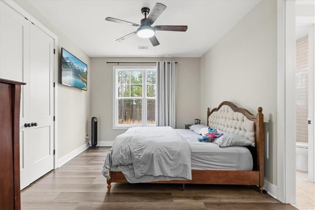 1270 McGarity Road Temple, GA 30179 - Photo 23 of 58 a bedroom with a bed and a chandelier