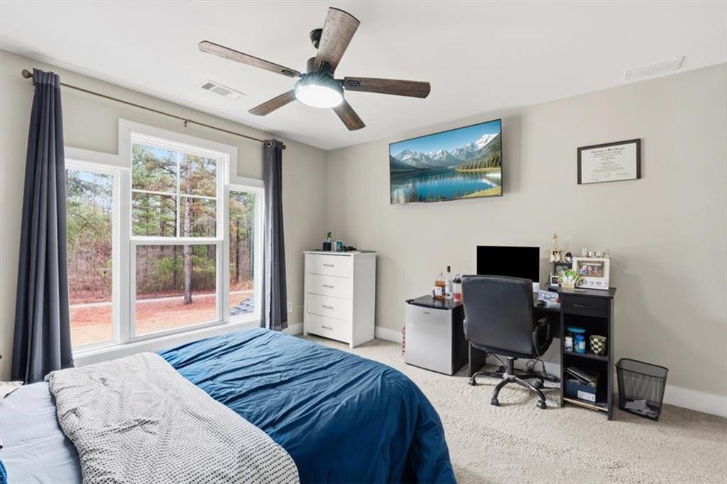 1270 McGarity Road Temple, GA 30179 - Photo 29 of 58 a bedroom with a bed and a desk