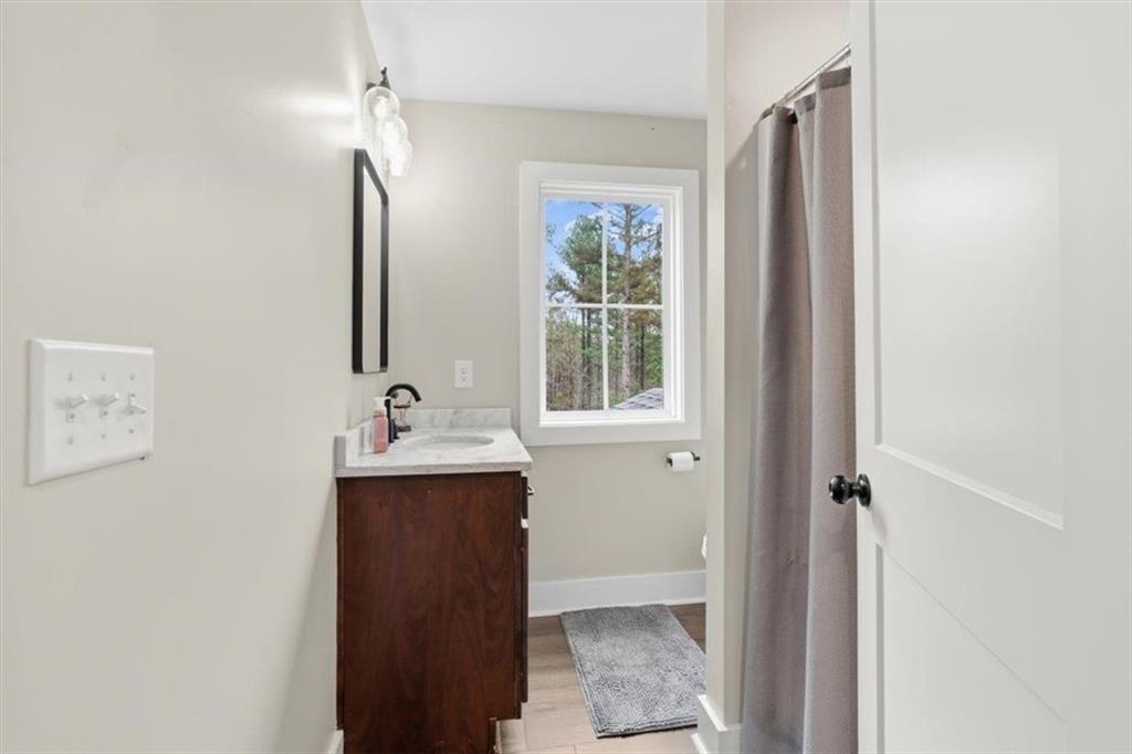 1270 McGarity Road Temple, GA 30179 - Photo 30 of 58 a bathroom with a sink and mirror with window