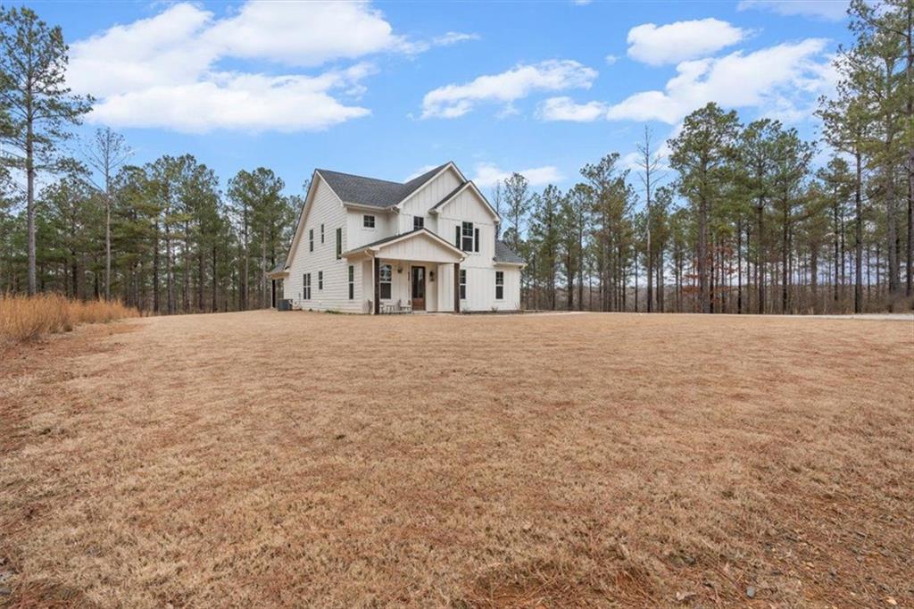 1270 McGarity Road Temple, GA 30179 - Photo 3 of 58 a front view of a house with a yard covered in snow