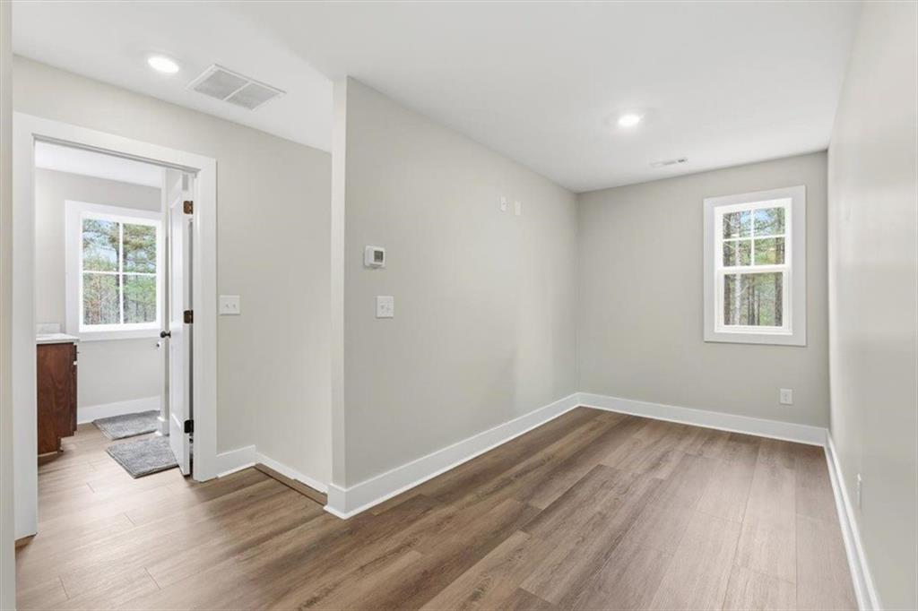 1270 McGarity Road Temple, GA 30179 - Photo 34 of 58 an empty room with wooden floor and windows