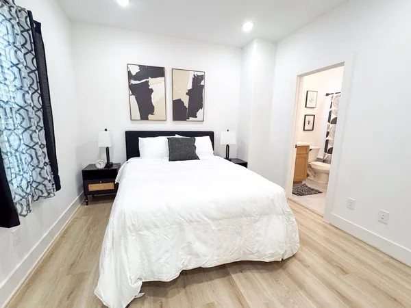 a large white bed in a white room