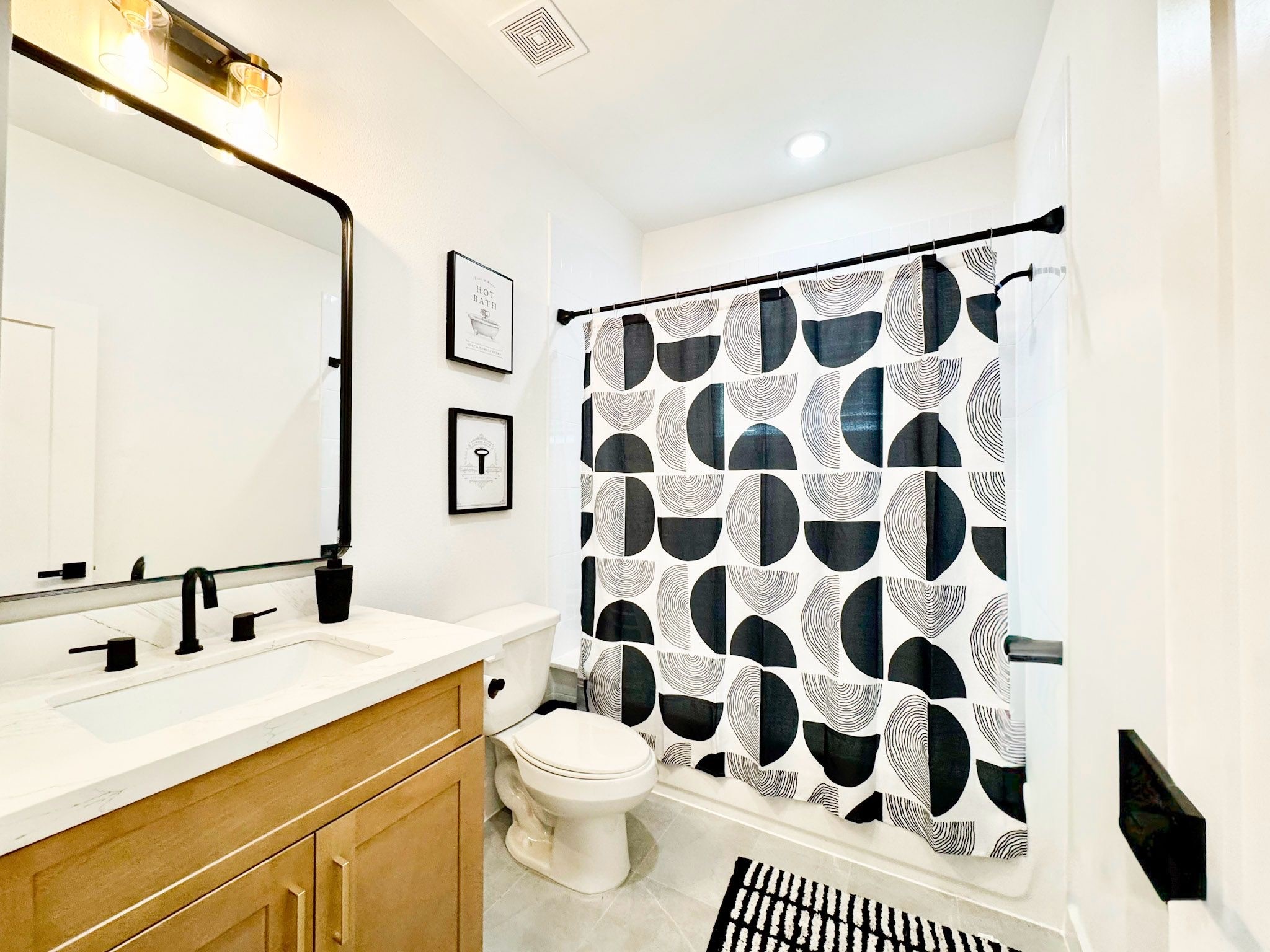 2706 Cochran Street Houston, TX 77009 - Photo 20 of 23 a bathroom with a sink a toilet a shower and a mirror
