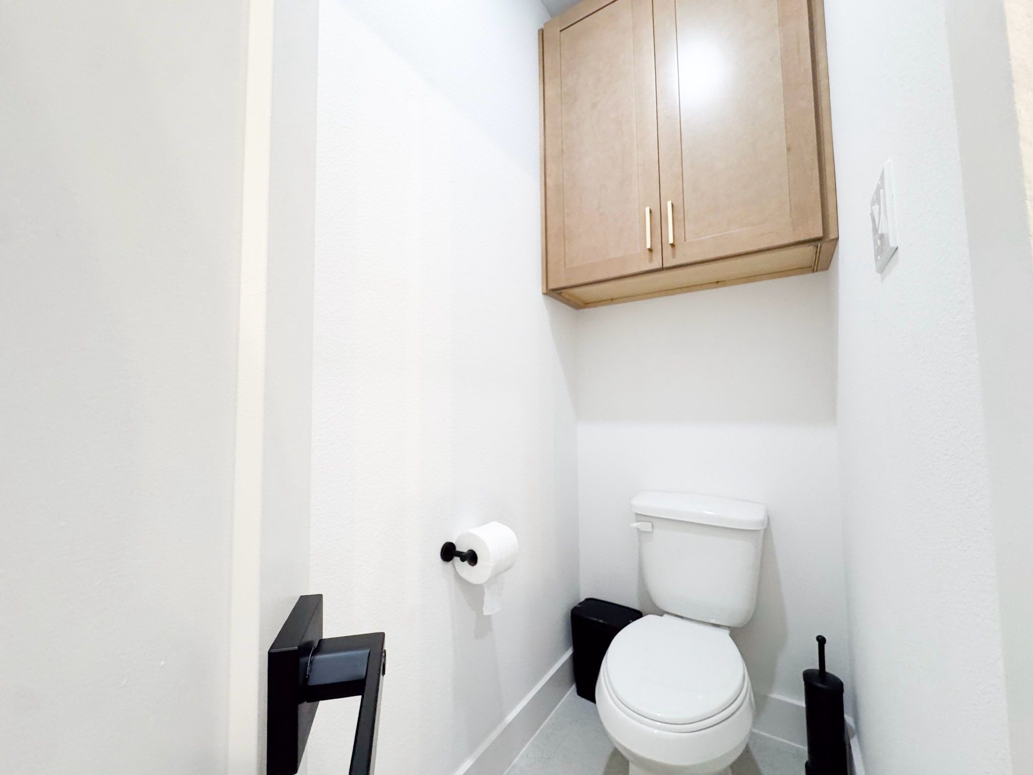 2706 Cochran Street Houston, TX 77009 - Photo 21 of 23 a white toilet sitting next to a white cabinet