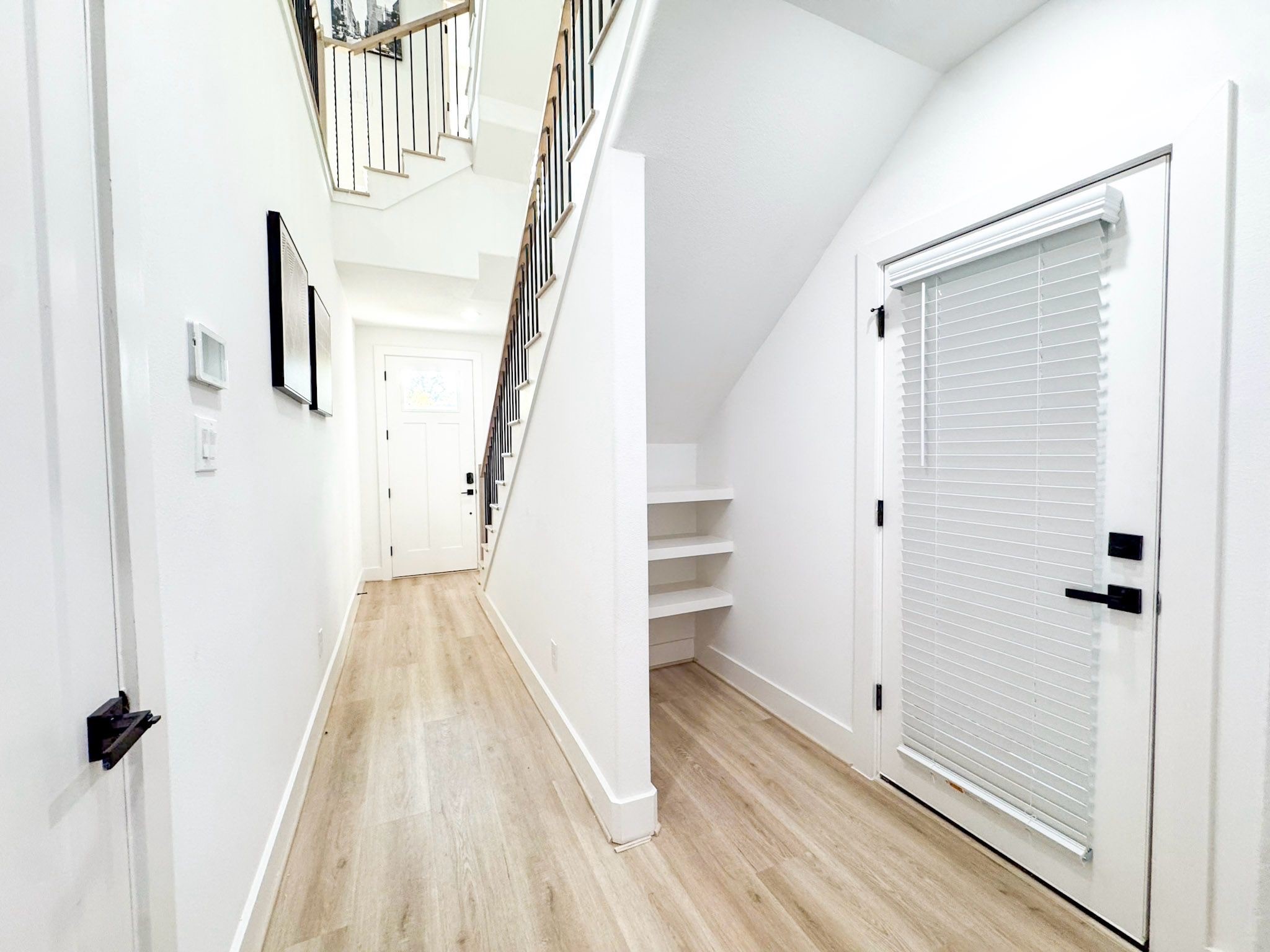 2706 Cochran Street Houston, TX 77009 - Photo 23 of 23 a view of a hallway with wooden floor and staircase