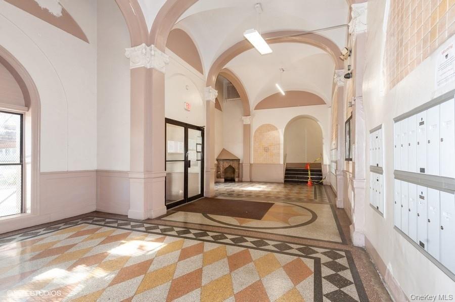 941 Jerome Avenue, Unit 11C Bronx, NY 10452 - Photo 11 of 14 Lobby with a high ceiling and wainscoting