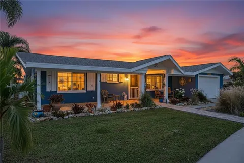 a view of a house with backyard and porch