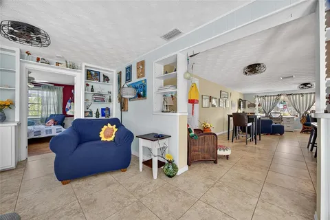 a living room with furniture and a gym machine