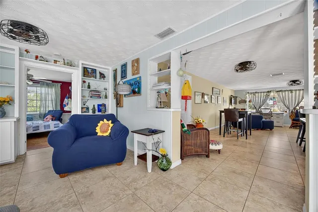a living room with furniture and a gym machine