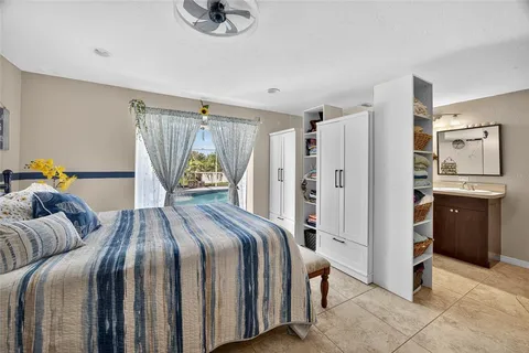 a bedroom with a bed and a refrigerator