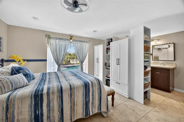 a bedroom with a bed and a refrigerator