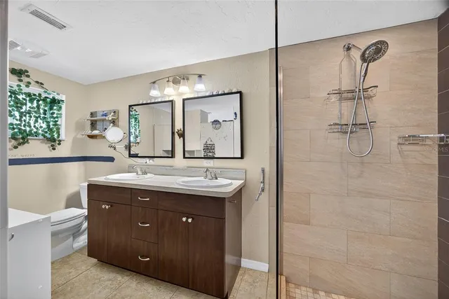 a spacious bathroom with a granite countertop sink mirror and double