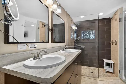 a bathroom with a sink double vanity and a mirror