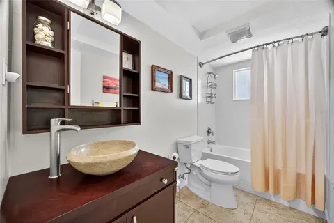 a bathroom with a toilet a sink and bathtub