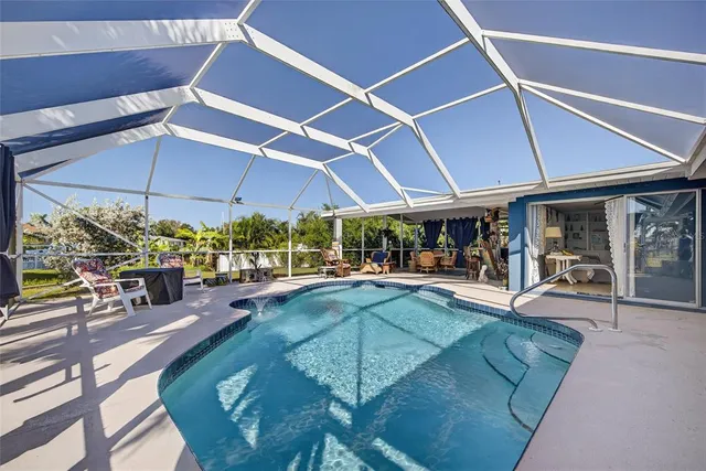 a view of a patio with table and chairs under an umbrella