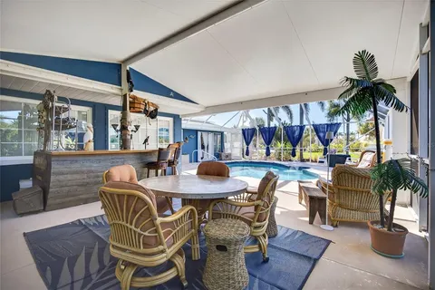 a dining room with furniture and a large window