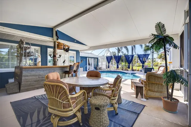 a dining room with furniture and a large window