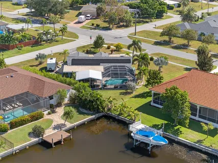 an aerial view of a house with swimming pool patio and outdoor seating