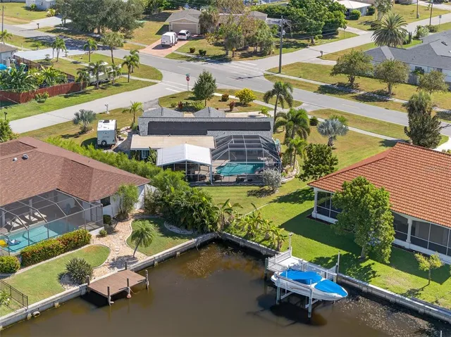 an aerial view of a house with swimming pool patio and outdoor seating
