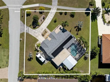 an aerial view of a house with a yard