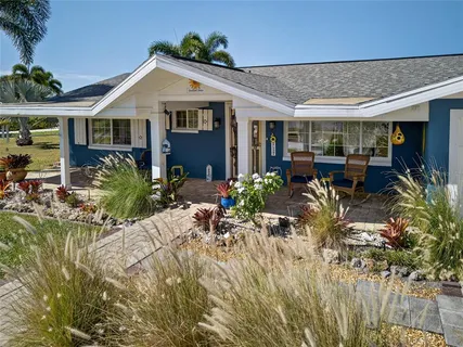 a view of a house with sitting area and garden