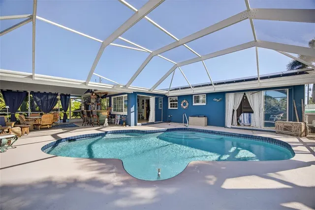 a view of a house with sitting area and swimming pool