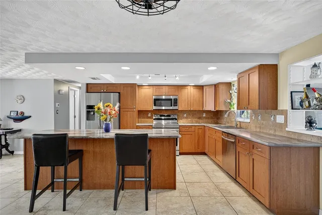 a kitchen with a sink a counter top space and appliances