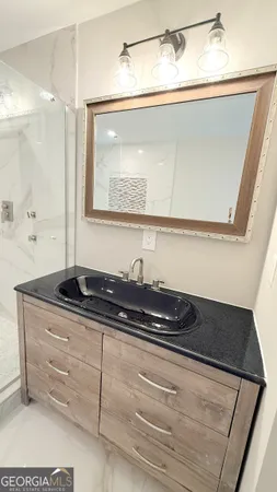 a bathroom with a bathtub and a double vanity sink mirror