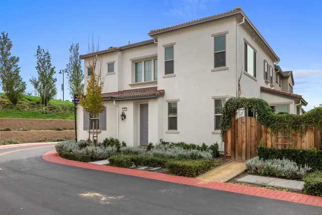 a view of a hallway with closet and a window