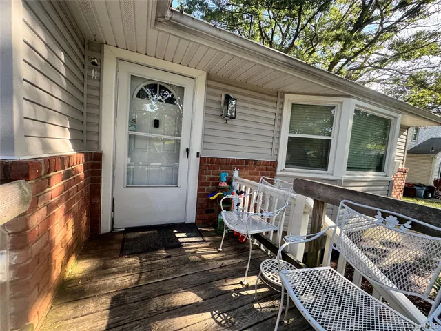 a view of a patio with two couches and wooden floor