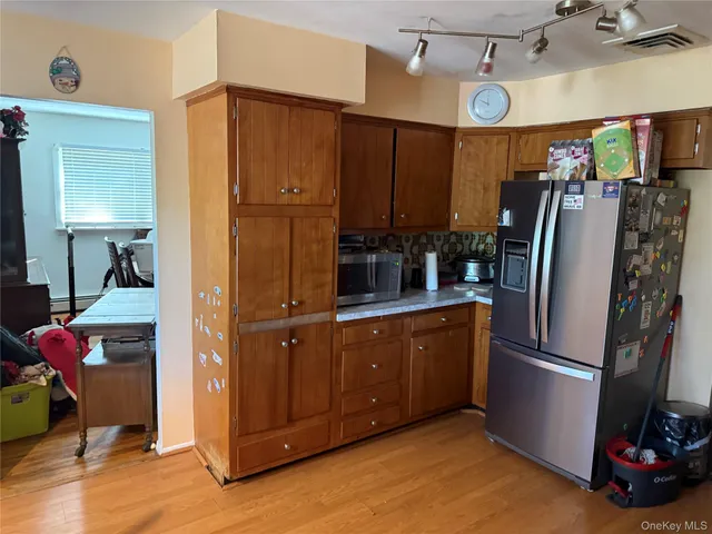 a kitchen with stainless steel appliances granite countertop a refrigerator and a sink