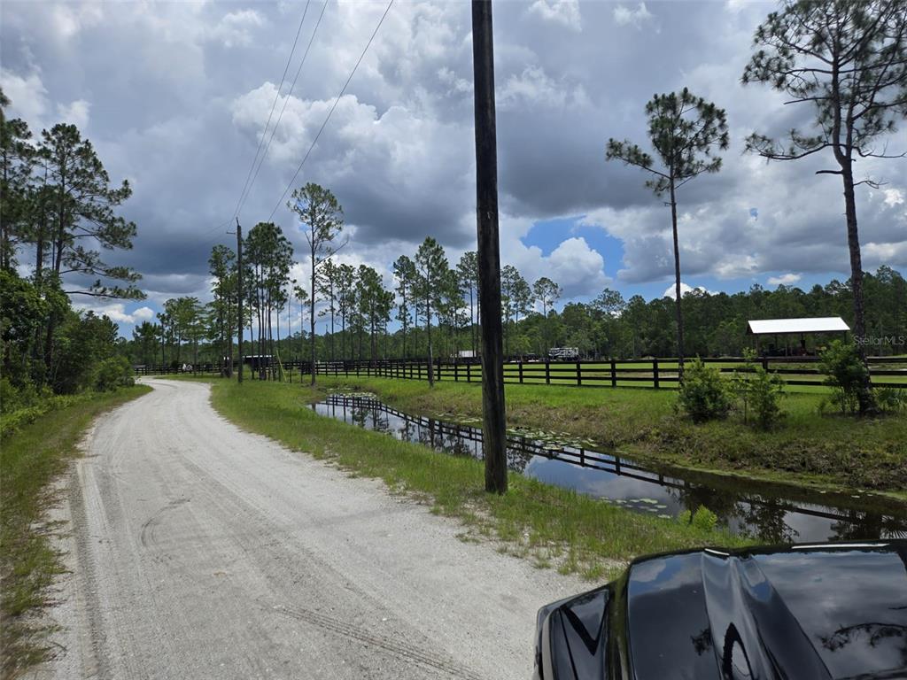 1135 Omega Ranch Road, Unit 4&5 Deltona, FL 32738 - Photo 2 of 11 a view of a park with large trees
