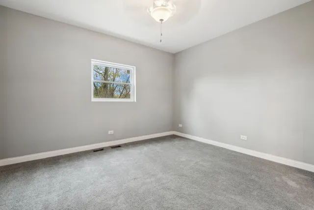 an empty room with a fan