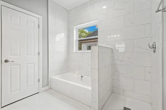 a white bath tub and shower