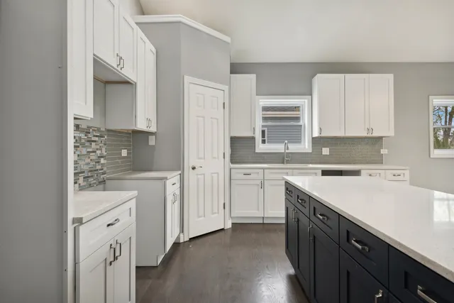 a kitchen with white cabinets and white appliances