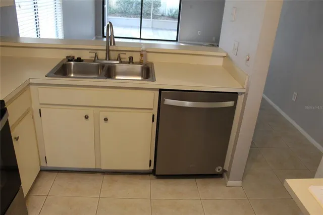 a kitchen with a sink and a washing machine
