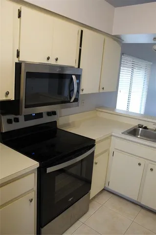 a kitchen with a sink and a microwave
