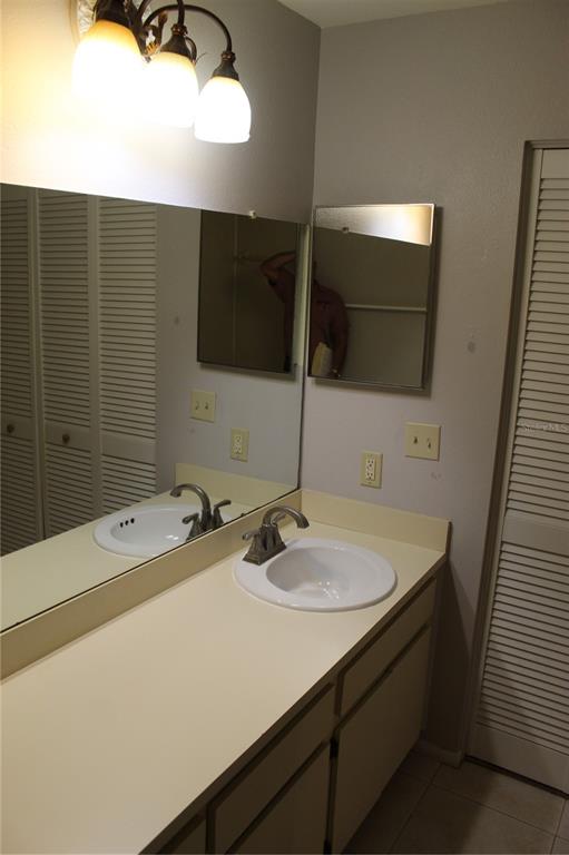 8418 Laurelon Place Temple Terrace, FL 33637 - Photo 8 of 13 a bathroom with a sink and mirror