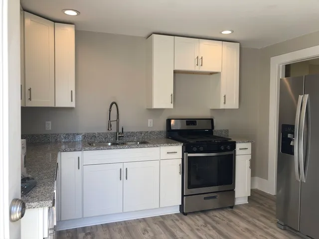 a kitchen with a sink stove and cabinets