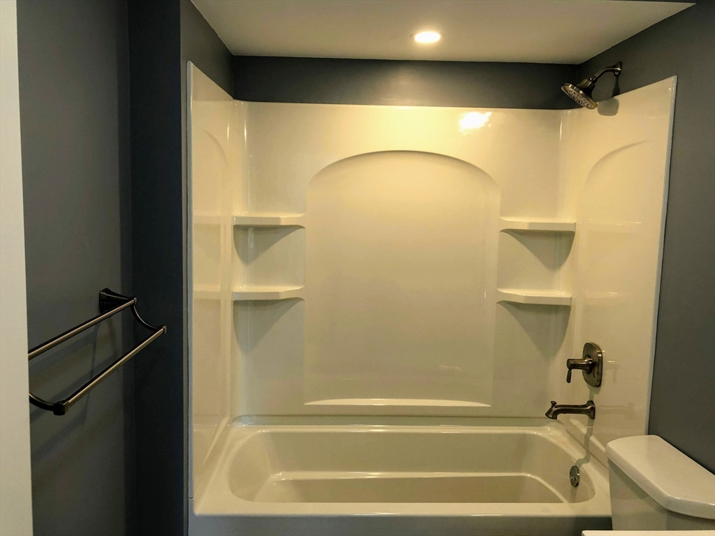 28-32 Calvary Street Waltham, MA 02453 - Photo 25 of 41 a bathroom with a shower and a bath tub