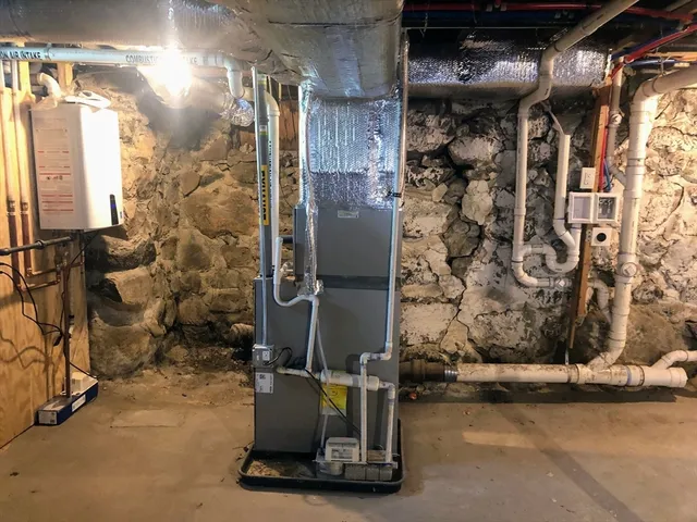 a room with water heater and a wooden door