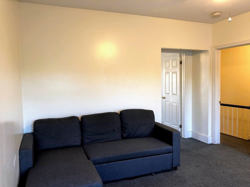 28-32 Calvary Street Waltham, MA 02453 - Photo 36 of 41 a living room with furniture and a window