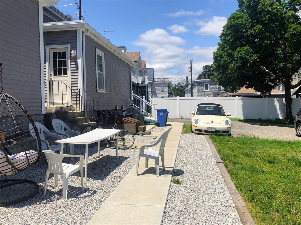 28-32 Calvary Street Waltham, MA 02453 - Photo 39 of 41 a white bench sitting in front of a house