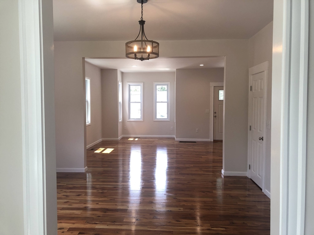 28-32 Calvary Street Waltham, MA 02453 - Photo 8 of 41 a view of a room with window and wooden floor